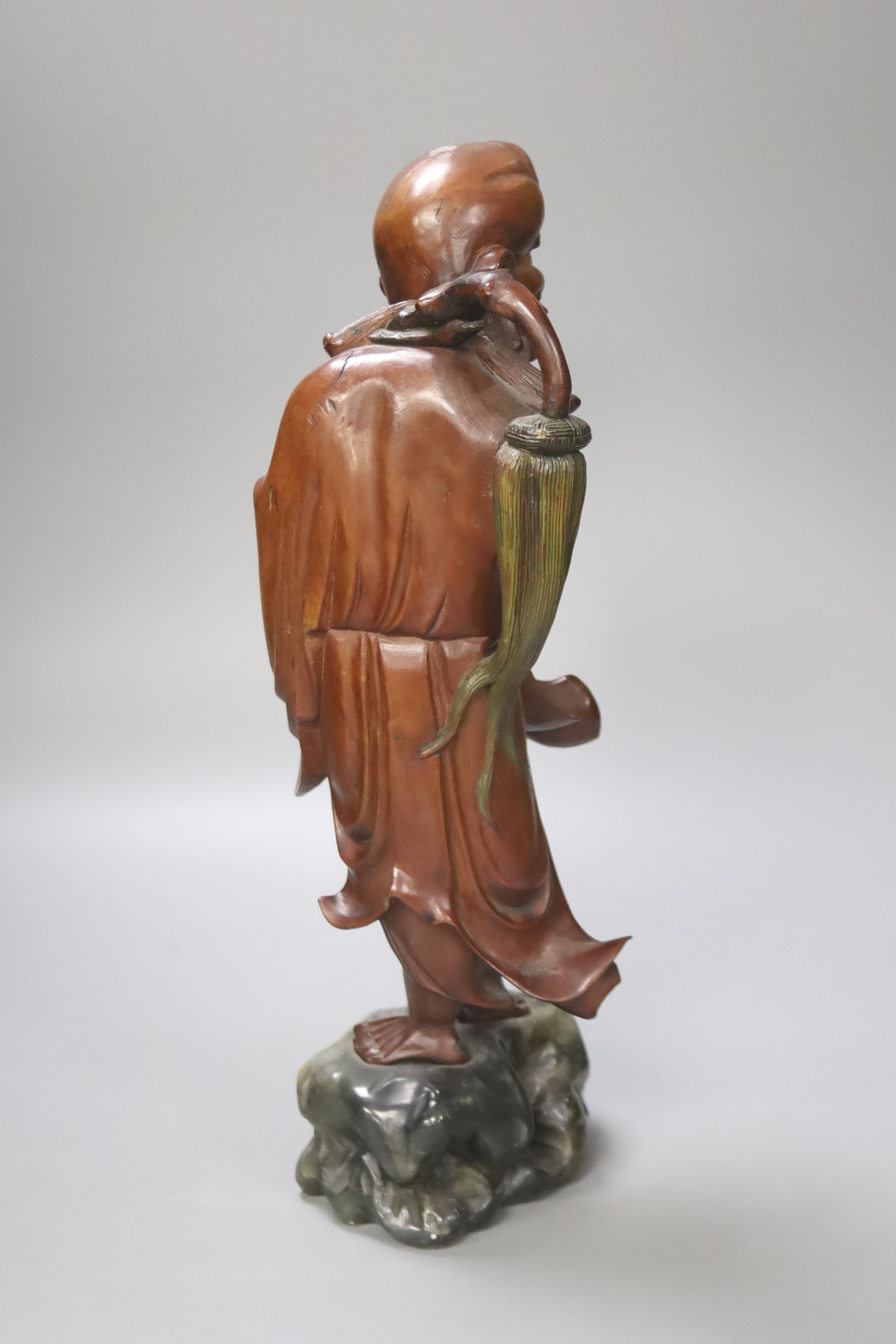 A Chinese root carving of a deity, 35cm high